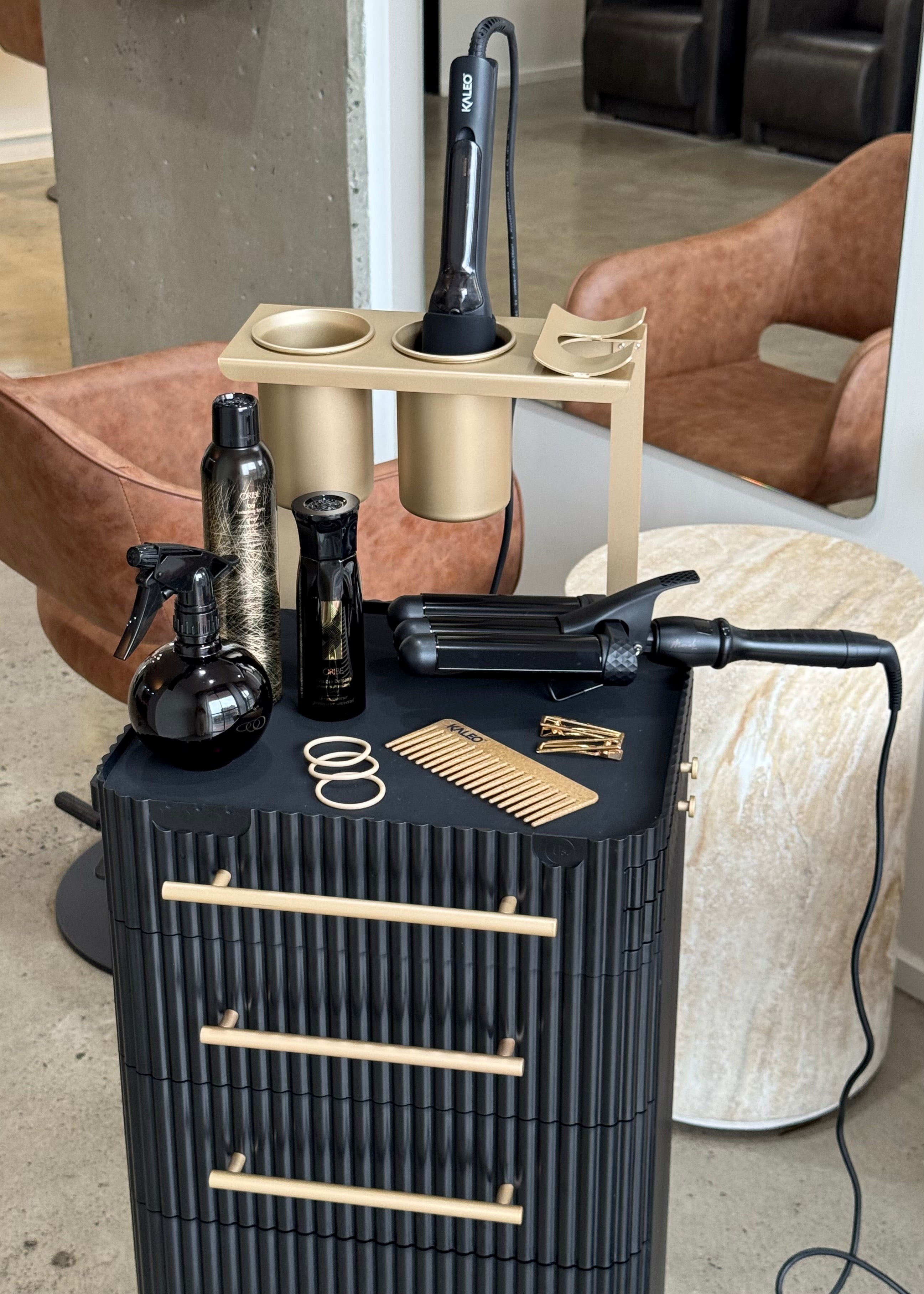 Barber station with hair care products and tools in a salon setting